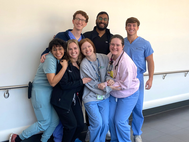 group of residents in scrubs standing in a hallway